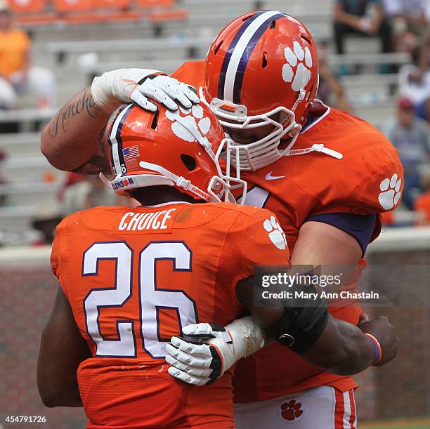 Runningback Adam Choice of the Clemson Tigers celebrates his touchdown with teammate Spencer Region during the fourth quarter as they defeated South...