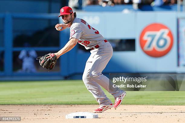 Pete Kozma of the St. Louis Cardinals throws the ball to first base during Game Five of the National League Championship Series against the Los...