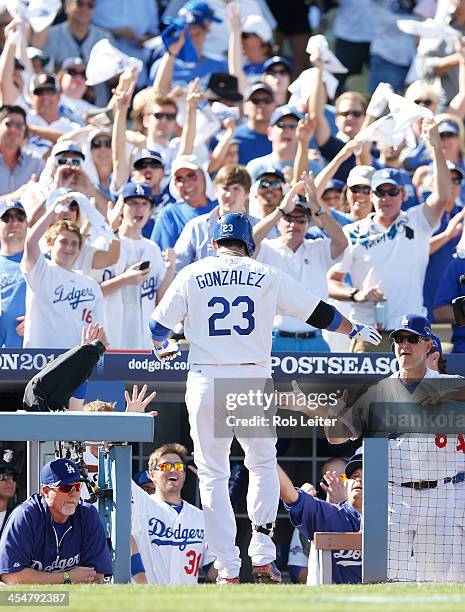 Fans cheer as Adrian Gonzalez of the Los Angeles Dodgers walks into the dugout during Game Five of the National League Championship Series against...