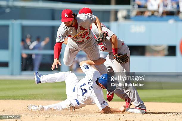 Mark Ellis of the Los Angeles Dodgers slides into Pete Kozma of the St. Louis Cardinals at second base during Game Five of the National League...
