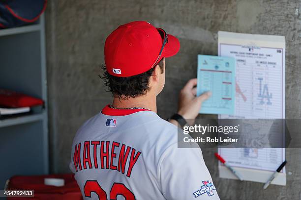 Mike Matheny of the St. Louis Cardinals looks over the rosters prior to Game Five of the National League Championship Series against the Los Angeles...