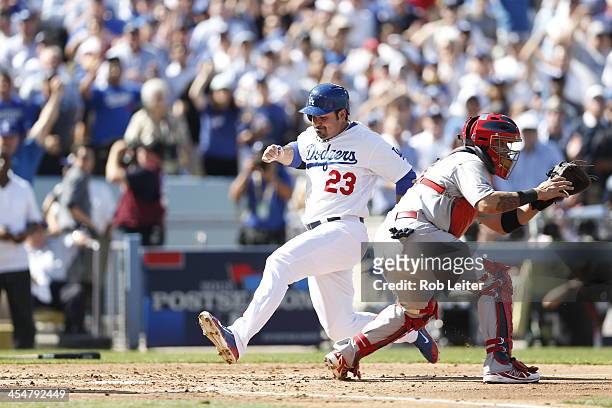 Adrian Gonzalez of the Los Angeles Dodgers scores the Dodgers first run during Game Five of the National League Championship Series against the St....