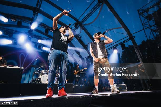 Rappers Bass Sultan Hengzt and Sido perform live on stage during 'Die Neuen Deutschpoeten Open Air Festival' at IFA Sommergarten on September 6, 2014...