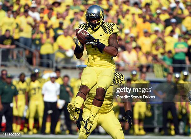 Defensive back Erick Dargan of the Oregon Ducks intercepts in the first quarter of the game against the Michigan State Spartans at Autzen Stadium on...