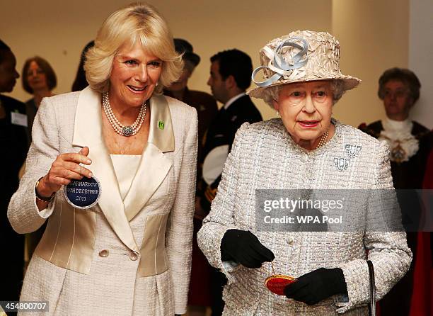 Camilla, Duchess of Cornwall and Queen Elizabeth II visit the new Barnardo's HQ in Barkingside on December 10, 2013 in London, England.