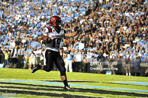 Donnel Pumphrey of the San Diego State Aztecs celebrates following a 12-yard touchdown during their game against the North Carolina Tar Heels on...