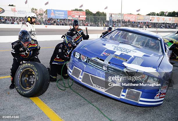 Joey McColm, driver of the PartSource/Toronto Maple Leafs Dodge stops for a tire change during the Hudco Electric Supply 300 at Barrie Speedway on...