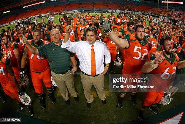 Miami Hurricanes head coach Al Golden cheers with the team after a game against the Florida A&M Rattlers at Sunlife Stadium on September 6, 2014 in...