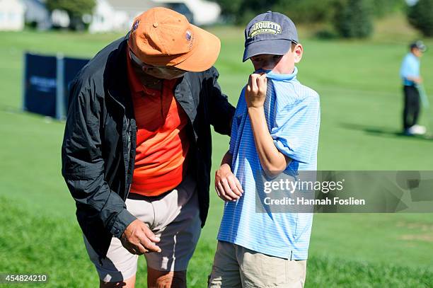 Regional Finals Boys 10-11 competitor is consoled at the Drive, Chip and Putt competition on September 6, 2014 in Blaine, Minnesota.