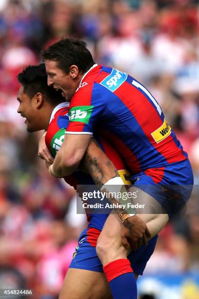 Kurt Gidley and Joey Leilua of the Knights celebrate the first try by Joey Leilua during the round 26 NRL match between the Newcastle Knights and the...