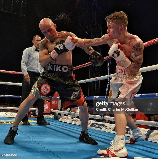 Carl Frampton of Northern Ireland lands a punch during the IBF super-bantamweight world title bout against world champion Kiko Martinez of Spain, at...