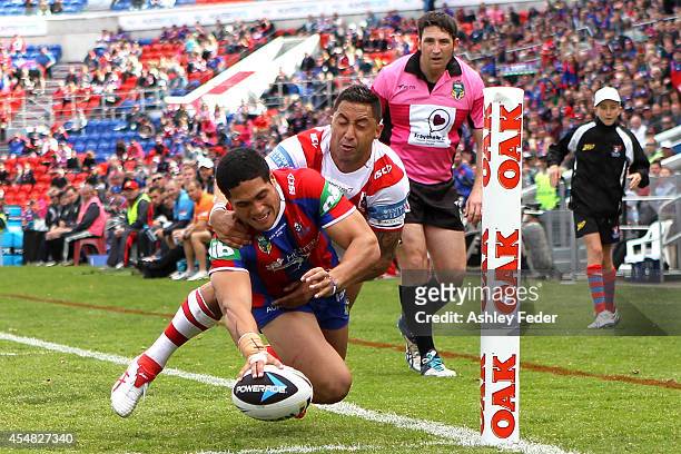 Sione Mata'Uita of the Knights scores a try during the round 26 NRL match between the Newcastle Knights and the St George Illawarra Dragons at Hunter...