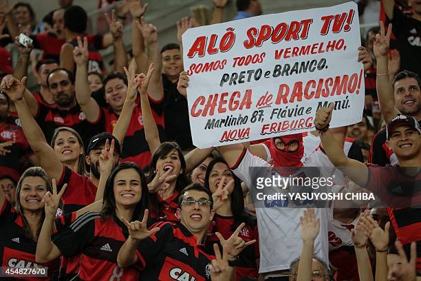 Flamengo's fans hold a placard against racism before their Brazilian championship match against Gremio, at Maracana stadium in Rio de Janeiro,...