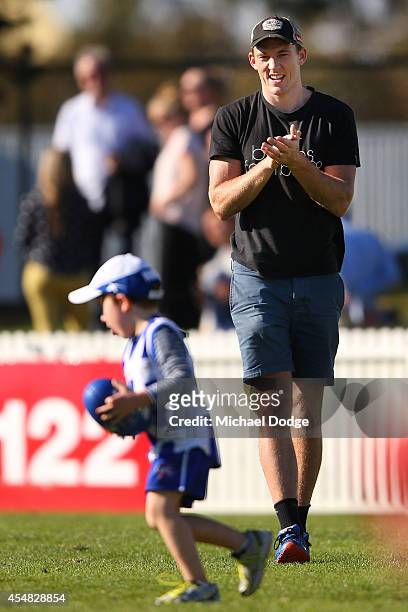 Drew Petrie of the Kangaroos, who kicked the winning goal against the Bombers last night, plays with his son Jack Petrie during the VFL Semi Final...