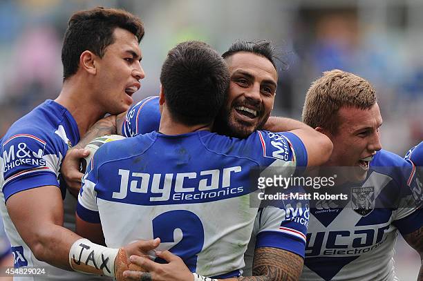 Reni Maitua of the Bulldogs celebrates scoring a try with team mates during the round 26 NRL match between the Gold Coast Titans and the Canterbury...