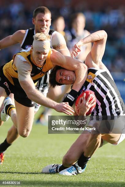 Steven Morris of the Tigers tackles Angus Monfries of the Power during the First Elimination Final match between the Port Adelaide Power and the...