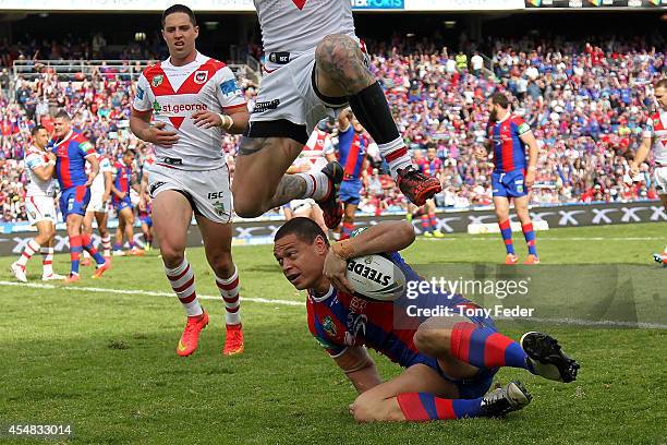 Timana Tahu of the Knights scores a try during the round 26 NRL match between the Newcastle Knights and the St George Illawarra Dragons at Hunter...