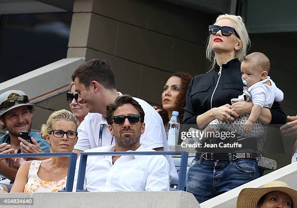 Henrik Lundqvist and his wife Therese Andersson, Gwen Stefani and her son Apollo Rossdale attend the men's semi finals during Day 13 of the 2014 US...