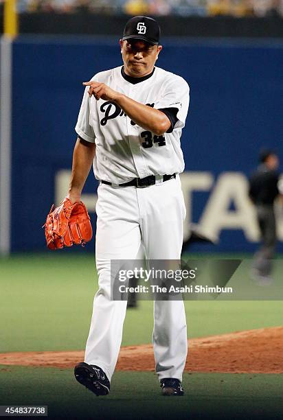 Starting pitcher Masahiro Yamamoto walks to the dugout after the top of third inning during the Central League game against Hanshin Tigers at Nagoya...