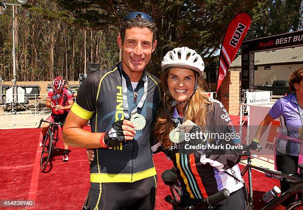 Professional cyclist George Hincapie and Best Buddies Challenge Event Co-Chair Maria Shriver pose at the finish line of the Best Buddies Challenge...