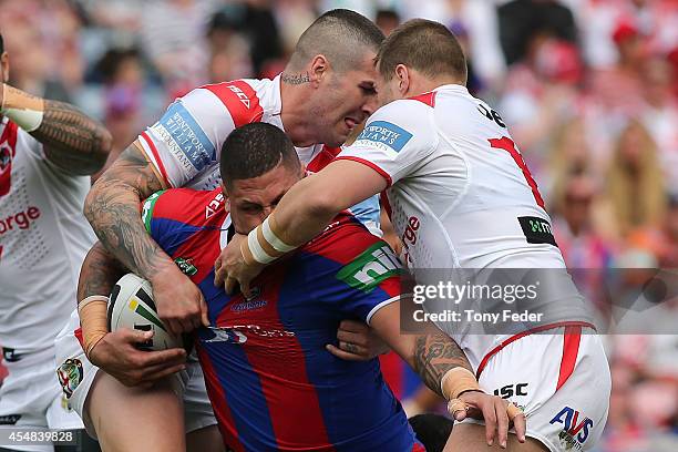 Willie Mason of the Knights is tackled by the Dragons defence during the round 26 NRL match between the Newcastle Knights and the St George Illawarra...