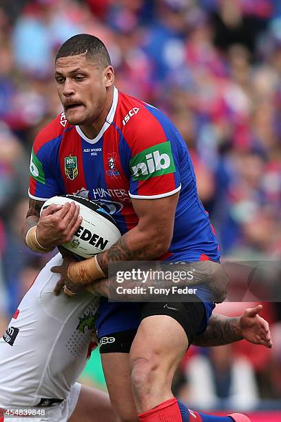 Willie Mason of the Knights is tackled by the Dragons defence during the round 26 NRL match between the Newcastle Knights and the St George Illawarra...