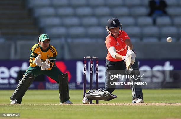 Lauren Winfield of England in action batting as Trisha Chetty of South Africa looks on during the NatWest Women's International T20 match between...