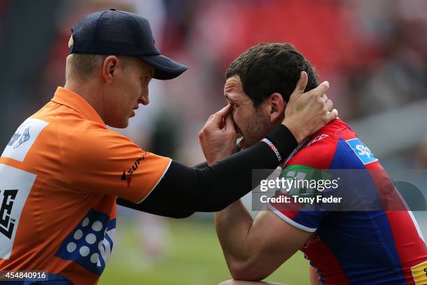 Jarrod Mullen of the Knights is treated on field during the round 26 NRL match between the Newcastle Knights and the St George Illawarra Dragons at...