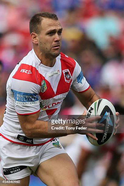 Jason Nightingale of the Dragons runs the ball during the round 26 NRL match between the Newcastle Knights and the St George Illawarra Dragons at...