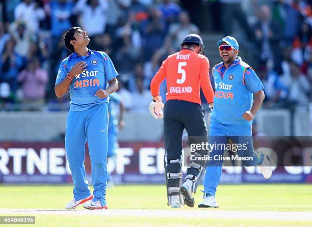 Karn Sharma of India celebrates dismissing Joe Root of England during the NatWest International T20 2014 match between England and India at Edgbaston...