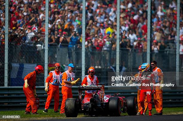 Fernando Alonso of Spain and Scuderia Ferrari leaves his car after retiring during the Italian Formula One Grand Prix at Autodromo di Monza on...