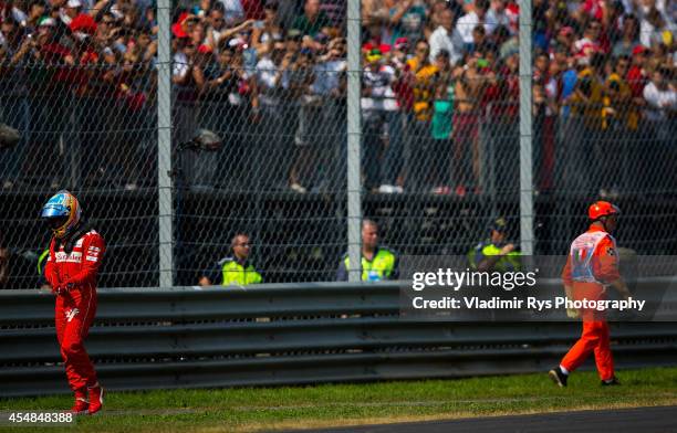 Fernando Alonso of Spain and Scuderia Ferrari leaves his car after retiring during the Italian Formula One Grand Prix at Autodromo di Monza on...