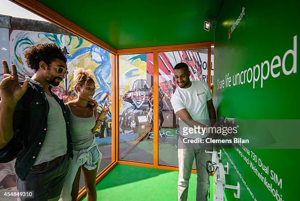 Visitors pose for a picture at the Nokia Lumia 735 Skype and Selfie Pod at the East Side Gallery on September 6, 2014 in Berlin, Germany.
