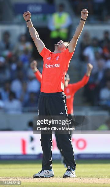 Chris Woakes of England celebrates dismissing Virat Kohli of India during the NatWest International T20 2014 match between England and India at...