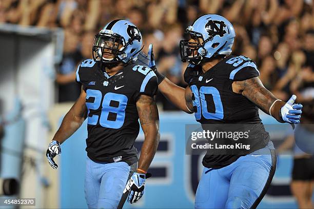 Brian Walker and Nazair Jones of the North Carolina Tar Heels react following a play against the San Diego State Aztecs on September 6, 2014 at Kenan...