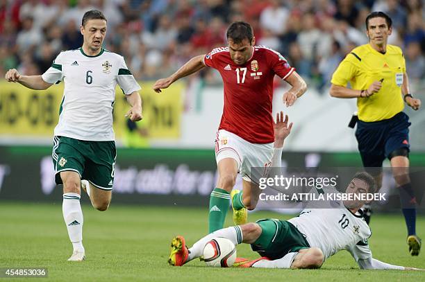 Northern Ireland's striker Kyle Lafferty vies for the ball with Hungary's forward Nemanja Nikolic during a qualification match for EURO 2016 between...