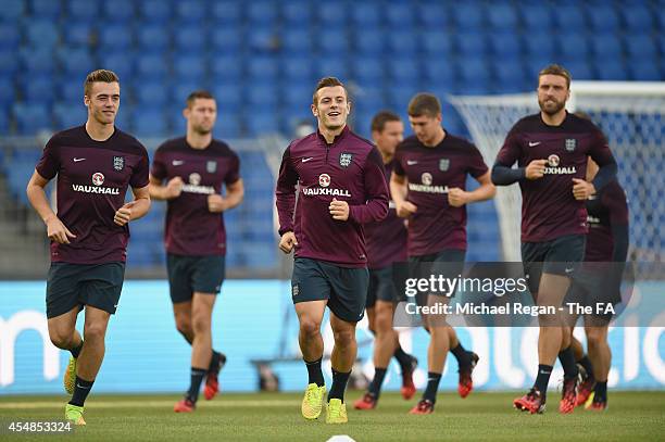 Calum Chambers, jack Wilshere and Rickie Lambert warm up ahead of the England training session at St. Jakob-Park on September 7, 2014 in Basel,...