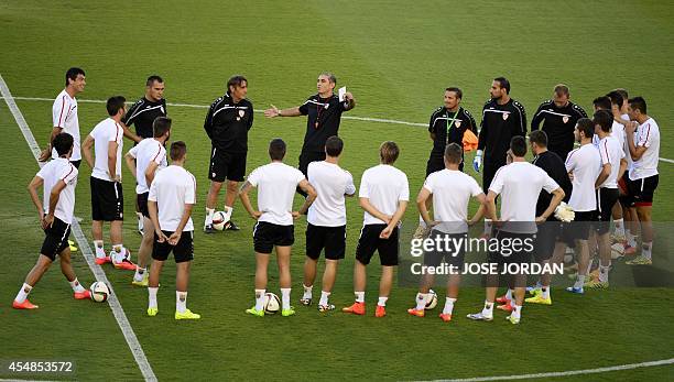 Macedonian'coach Bosko Gjurovski talks to his players during a training session at the Ciudad de Valencia stadium in Valencia on September 7 on the...