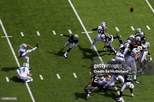 Nick Folk of the New York Jets kicks a field goal against the Oakland Raiders in the first quarter at MetLife Stadium on September 7, 2014 in East...