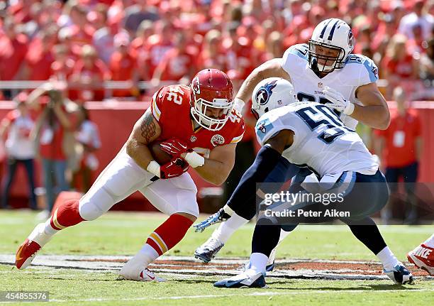 Anthony Sherman of the Kansas City Chiefs runs the ball against Zaviar Gooden of the Tennessee Titans during the first quarter at Arrowhead Stadium...