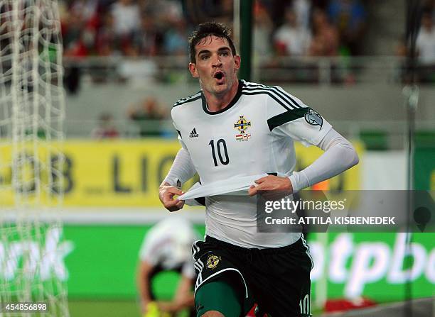 Northern Ireland's forward Kyle Lafferty celebrates scoring against Hungary during a qualification match for EURO 2016 between Hungary and Northern...