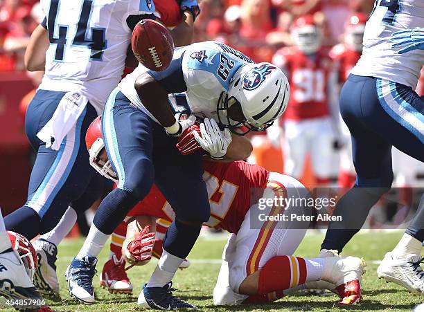 Anthony Sherman of the Kansas City Chiefs knocks the ball loose from Leon Washington of the Tennessee Titans for a fumble during the first half at...