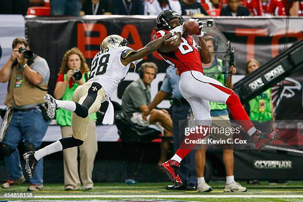 Roddy White of the Atlanta Falcons catches a touchdown pass with coverage by Keenan Lewis of the New Orleans Saints in the first half at the Georgia...