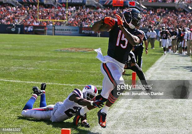 Brandon Marshall of the Chicago Bears slips by Leodis McKelvin of the Buffalo Bills to score a third quarter touchdown at Soldier Field on September...