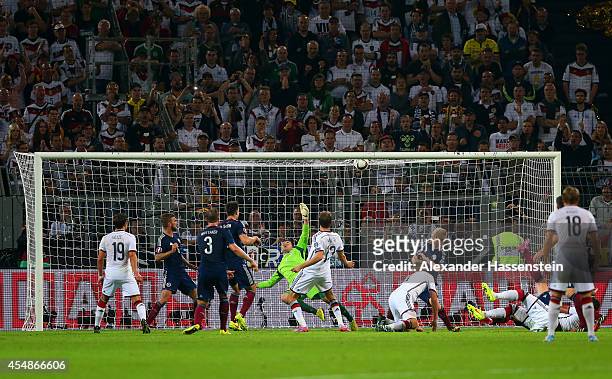 Thomas Mueller of Germany shoots past goalkeeper David Marshall of Scotland to score their second goal during the EURO 2016 Group D qualifying match...