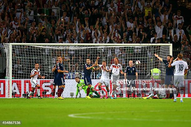 Thomas Mueller of Germany celebrates scoring their second goal during the EURO 2016 Group D qualifying match between Germany and Scotland at Signal...