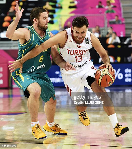 Turkey's forward Ender Arslan vies with Australia's guard Adam Gibson during the 2014 FIBA World basketball championships round of 16 match Turkey vs...