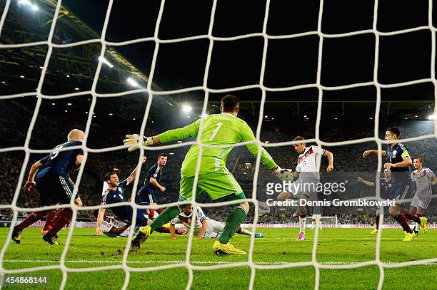 Thomas Mueller of Germany scores their second goal during the EURO 2016 Group D qualifying match between Germany and Scotland at Signal Iduna Park on...