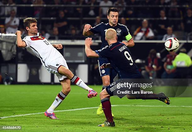 Thomas Mueller of Germany scores their second goal during the EURO 2016 Group D qualifying match between Germany and Scotland at Signal Iduna Park on...