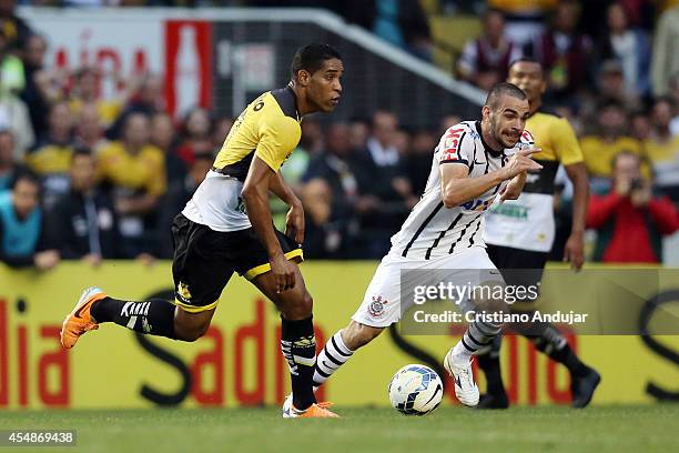 Anderson Martins of Corinthians try to stop Cleber Santana 10 of Criciuma during a match between Criciuma and Corinthians as part of Campeonato...